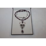 A Sterling silver garnet and white sapphire necklace and pair of ear-rings