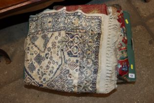 A box containing various curtains, rugs etc.