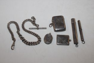 A silver vesta case; a silver stamp case; a silver
