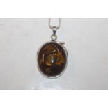 A large Sterling silver and amber pendant on chain