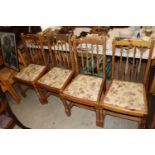 A set of four pine dining chairs
