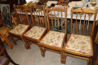 A set of four pine dining chairs