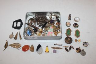 A tin containing brooches, ear-rings, studs etc.
