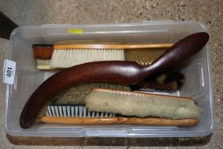 A box of various vintage brushes