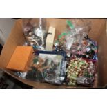 A box containing chess pieces; various costume jew
