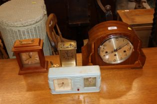 A walnut cased three hole mantel clock together wi