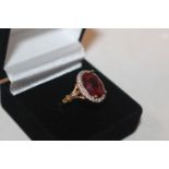 A 925 silver gilt ring set with ruby coloured ston