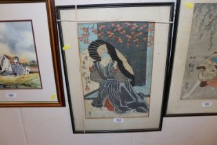 A signed Japanese print of lady sheltering under l