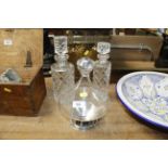 A graduated pair of cut glass decanters and a glas