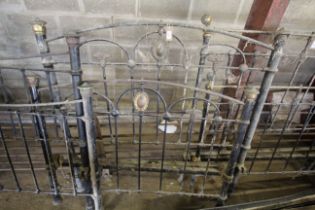 An ornate Victorian brass and iron double bed fram