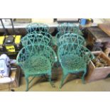 A set of four ornate green painted metal garden ar