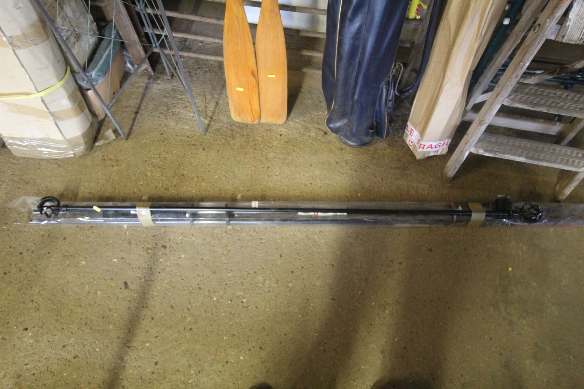 A metal curtain pole with rings and original packa