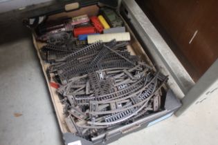 A box containing tin plate and other model trains