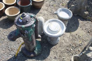 A garden water feature in the form of a hand pump,