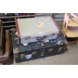 A large metal bound travel trunk and a smaller sui