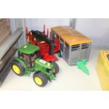 A Bruder 1/16th John Deere 6920 tractor with Bruder log trailer, logs and Bruder cattle trailer