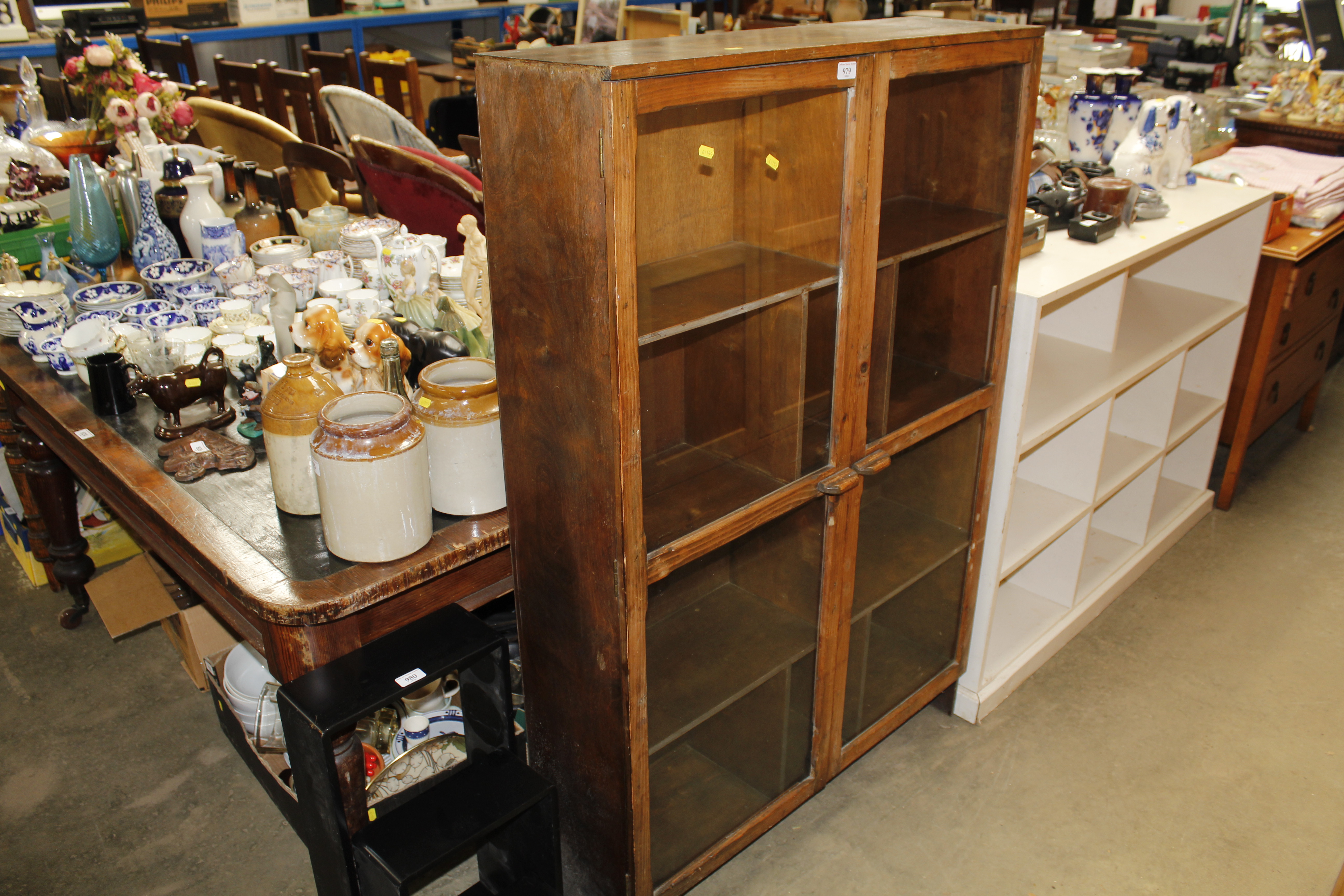 A stained pine and glazed cabinet