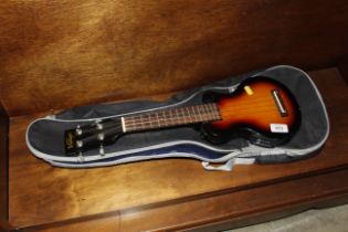 A vintage electric ukulele in carrying bag