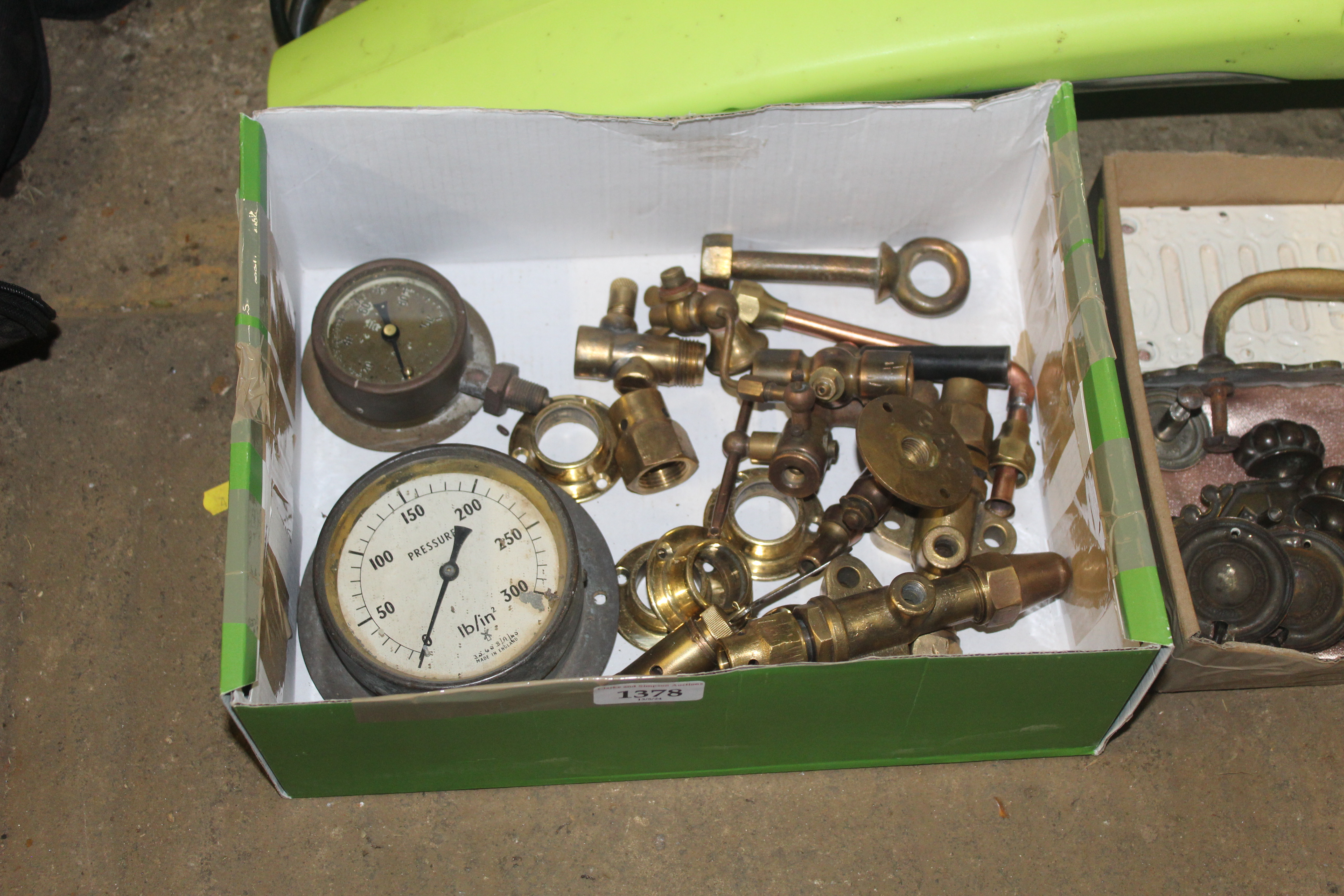 A box containing a pressure gauge, a quantity of v