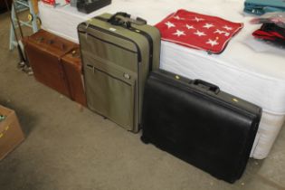A vintage suitcase and two other cases