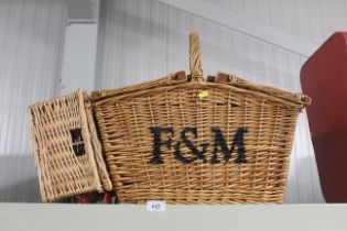 A Fortnum & Mason picnic basket and smaller baske
