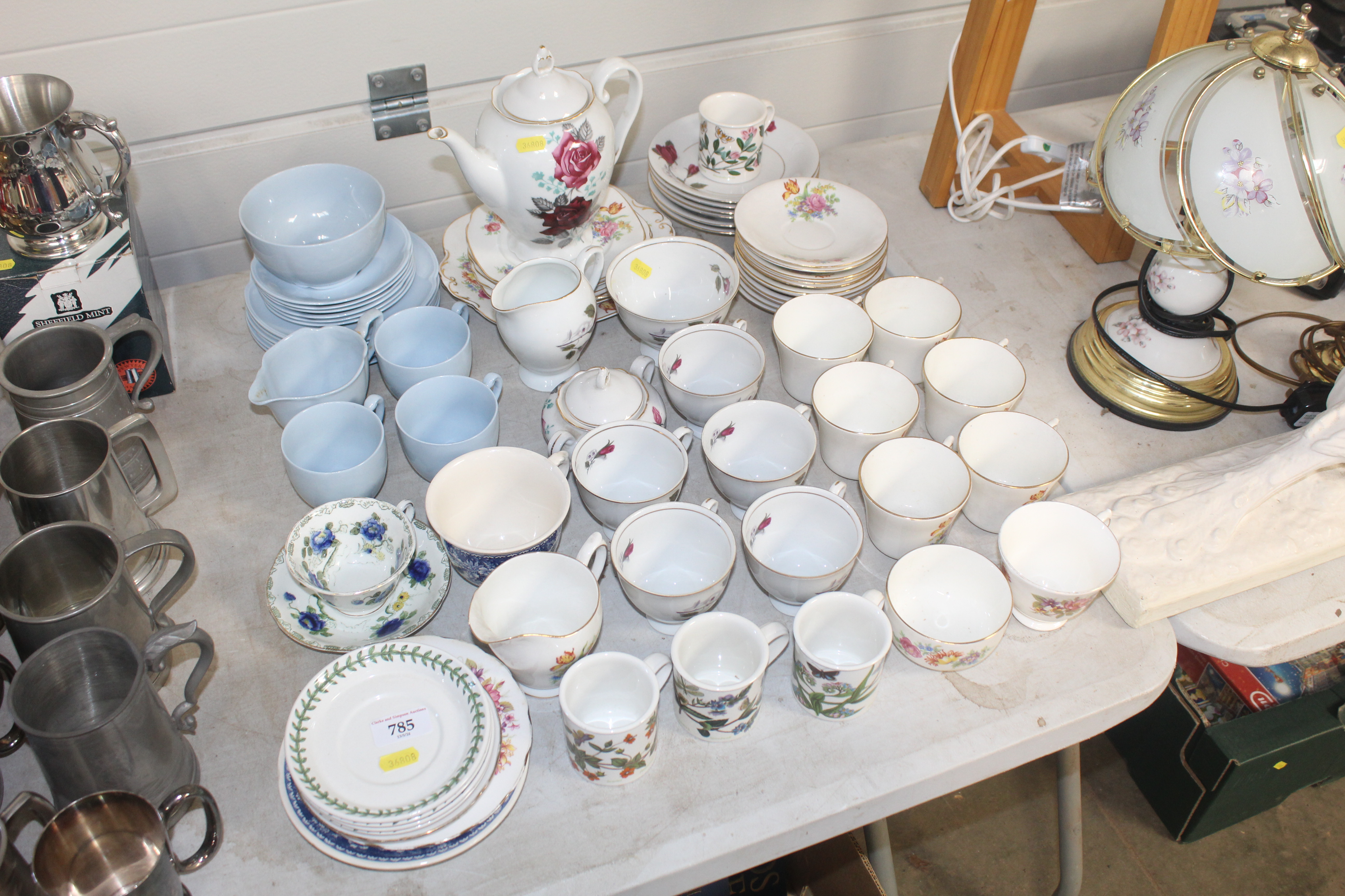 A collection of various patterned tea ware