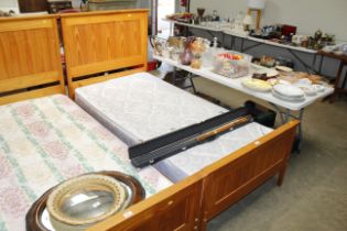 A pine framed single bed and mattress