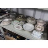 A collection of various patterned dinnerware