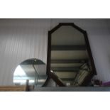 An oak framed and bevel edged wall mirror and circ