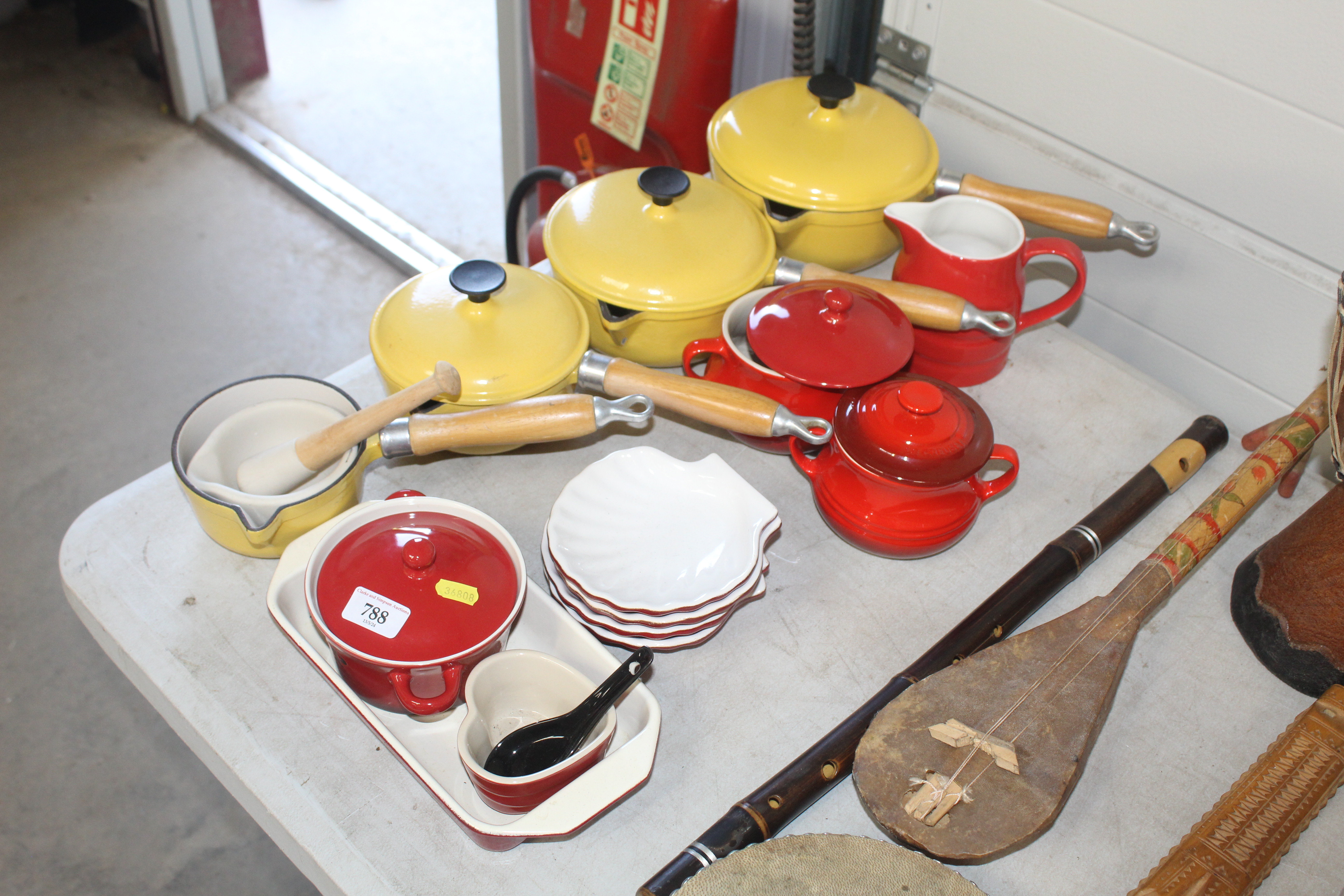 A graduated set of three Le Creuset style saucepan