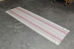 An approx. 7'10" x 2'5" modern pattern rug