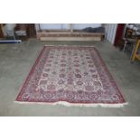 An approx. 10'4" x 6'6" red patterned rug AF