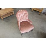 A Victorian button back upholstered armchair