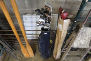 A vintage golf bag and quantity of vintage clubs t