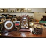 A cuckoo clock, an oak cased two hole mantel clock