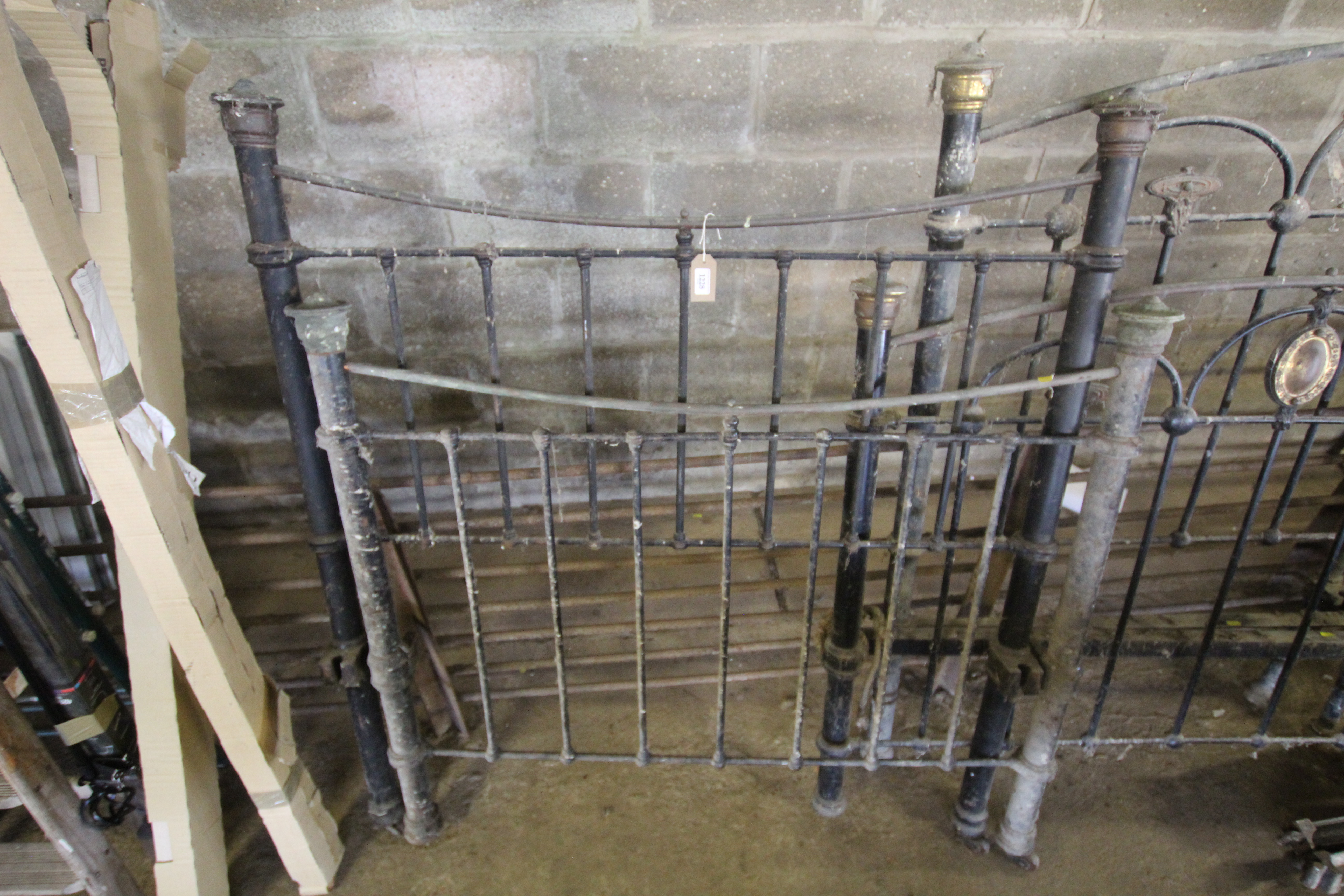 An ornate Victorian brass and iron bed (lacking ir
