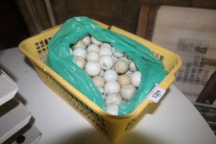A plastic crate containing a quantity of used golf