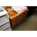 A light oak chest fitted three drawers