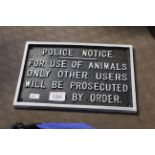 A painted cast iron sign for "Police Notice - for