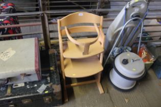 A wooden adjustable child's highchair