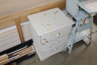 A painted pine bedside chest fitted three drawers