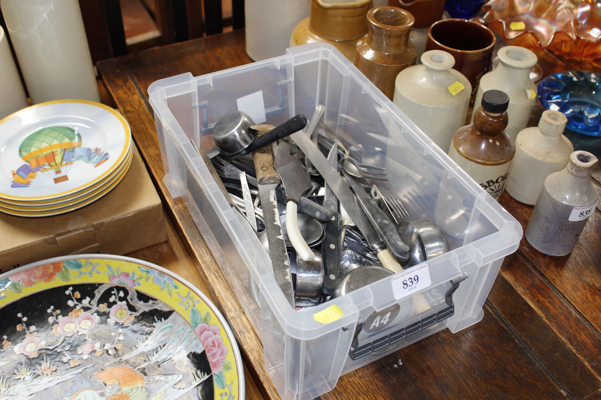 A box of cutlery and kitchen utensils