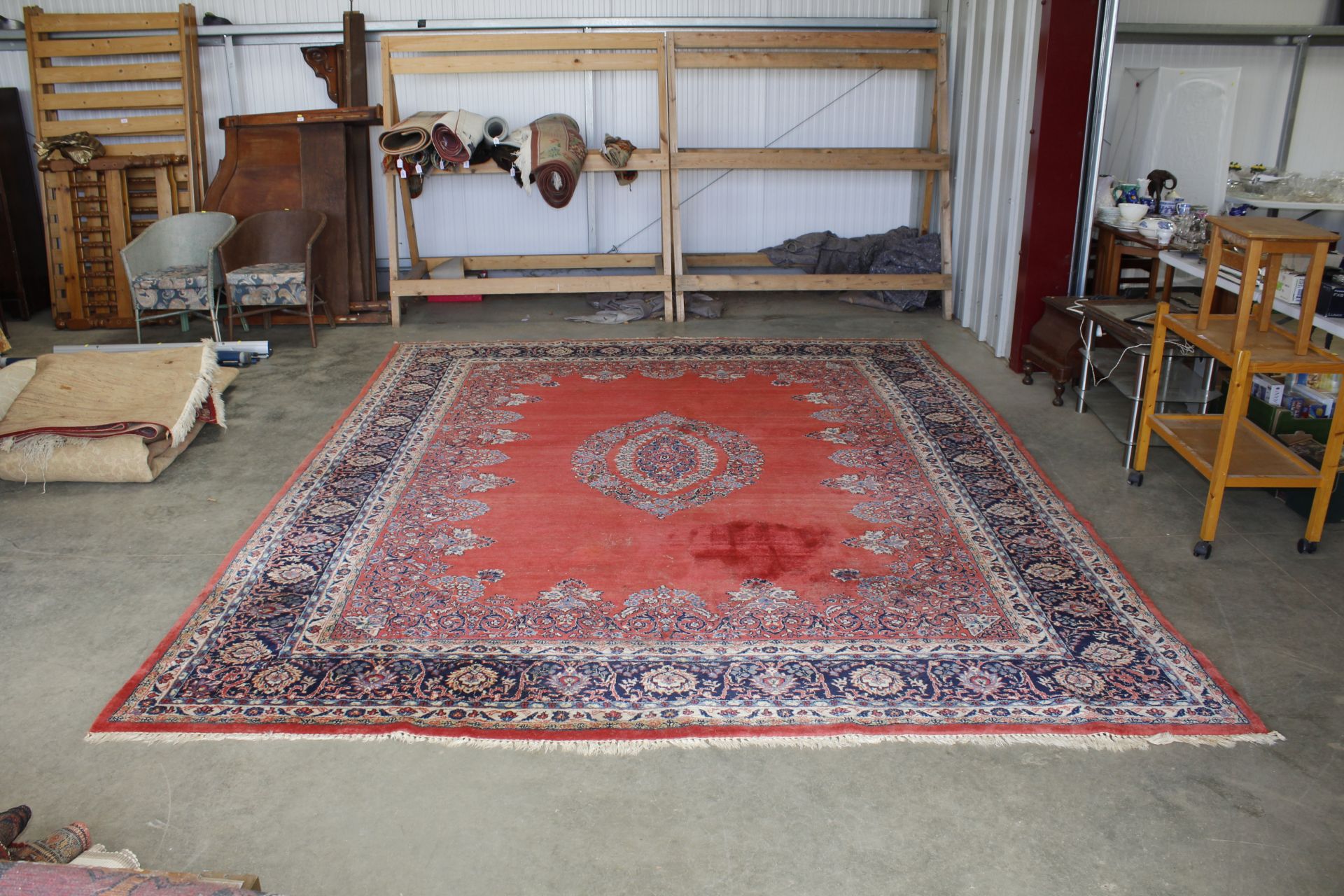 An approx. 12'9" x 9'8" red patterned rug AF