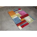 An approx. 5'8" x 4' modern patterned rug