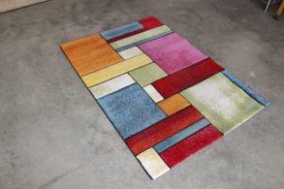 An approx. 5'8" x 4' modern patterned rug