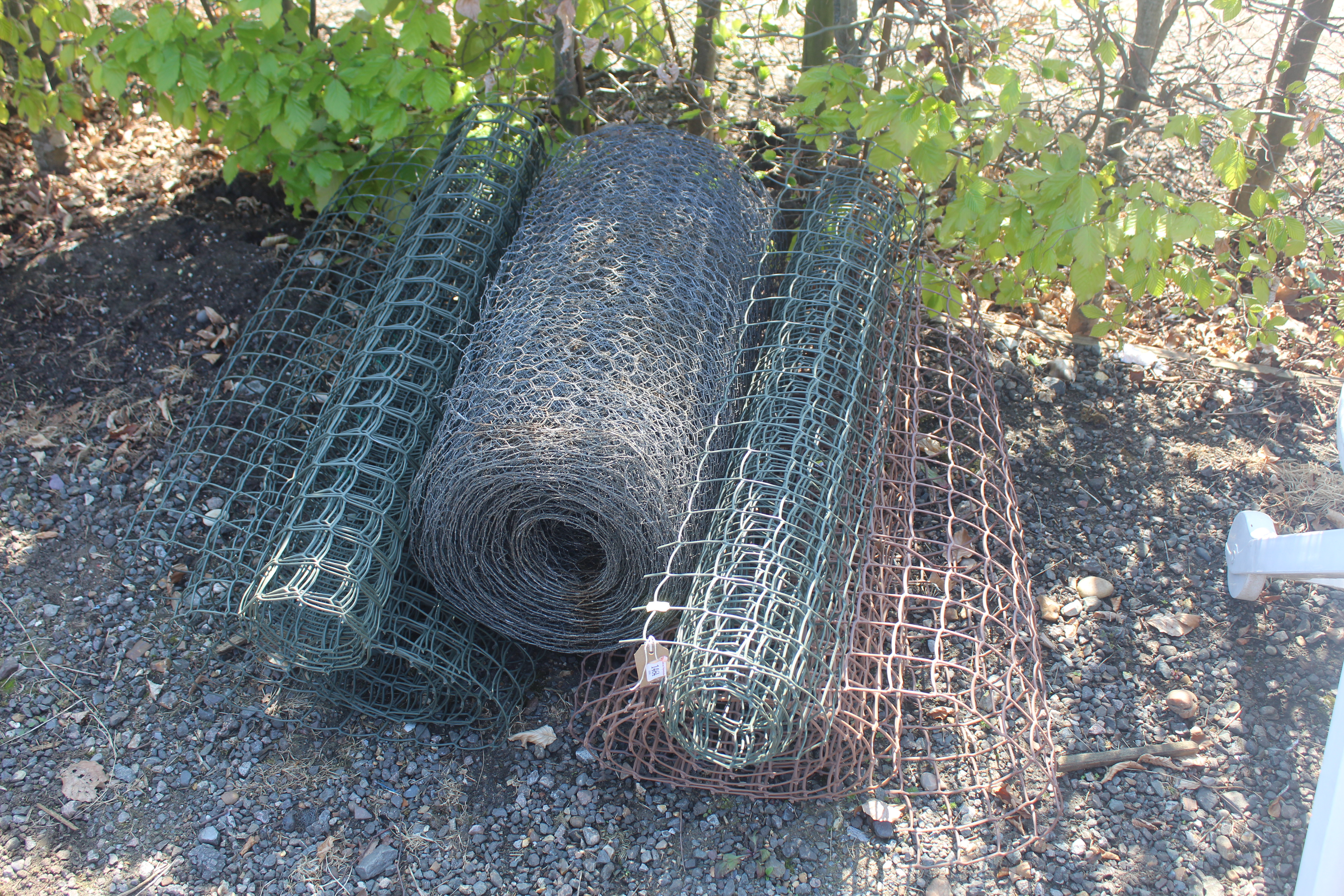 A quantity of plastic coated wire netting an a rol