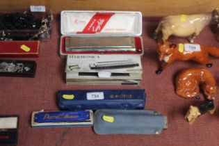 A Larry Adler harmonica and four others