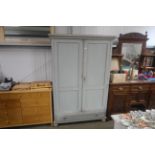 A painted pine wardrobe fitted single drawer below