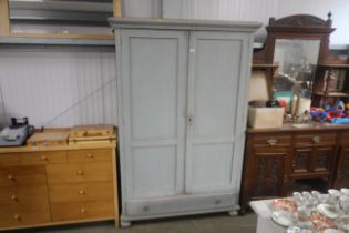A painted pine wardrobe fitted single drawer below