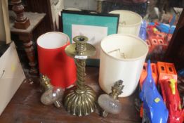 A brass candlestick; two brass and glass oil lamp